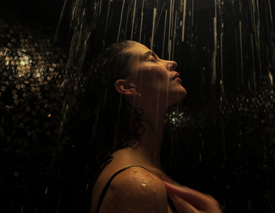 Woman showering in the wellness shower at THE SPA in St. Moritz.