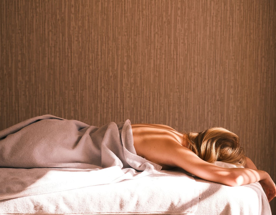Woman lying on a massage table at THE SPA.