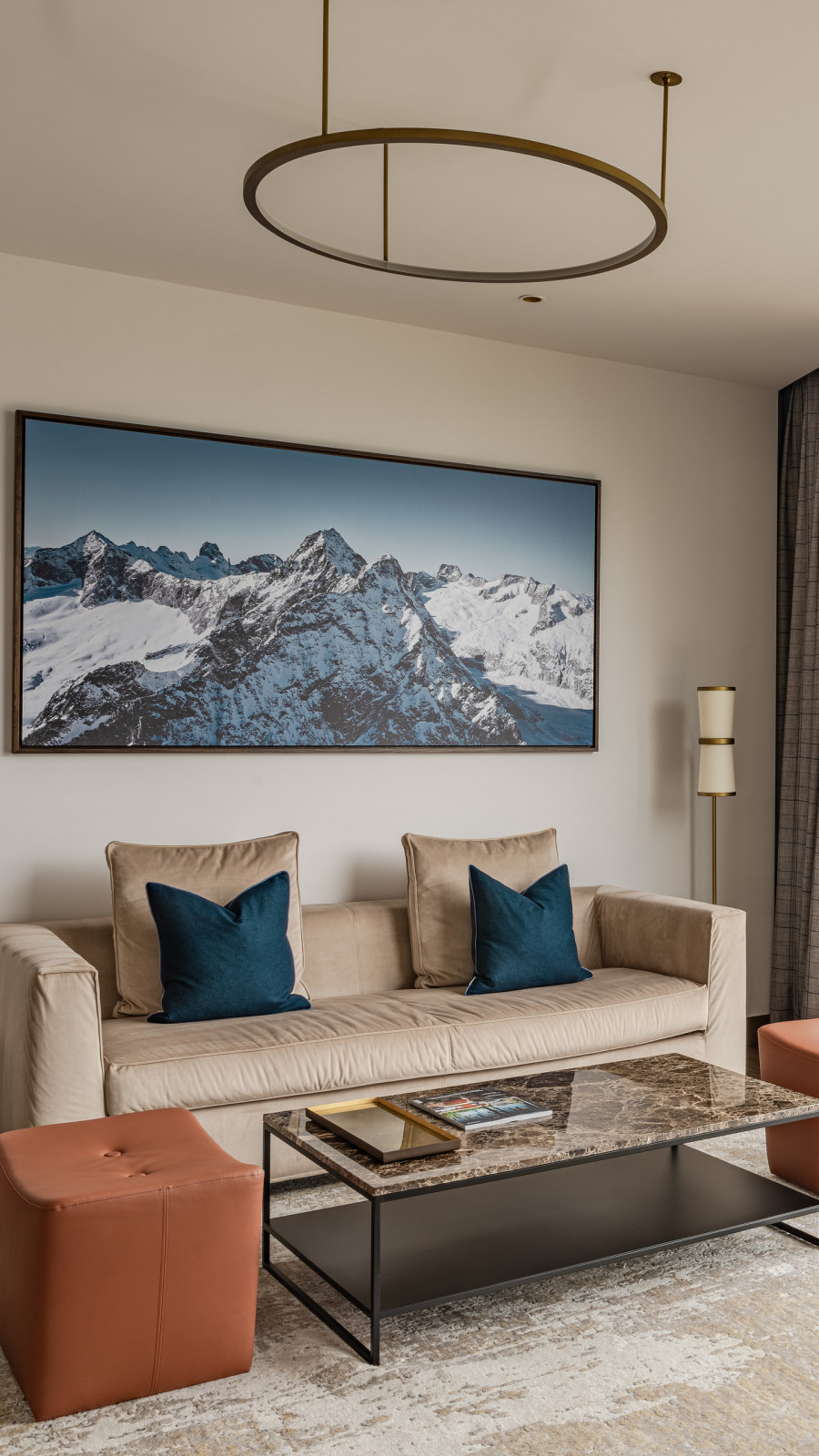 Lounge area in a hotel room with sofa and a table light up by the sunshine