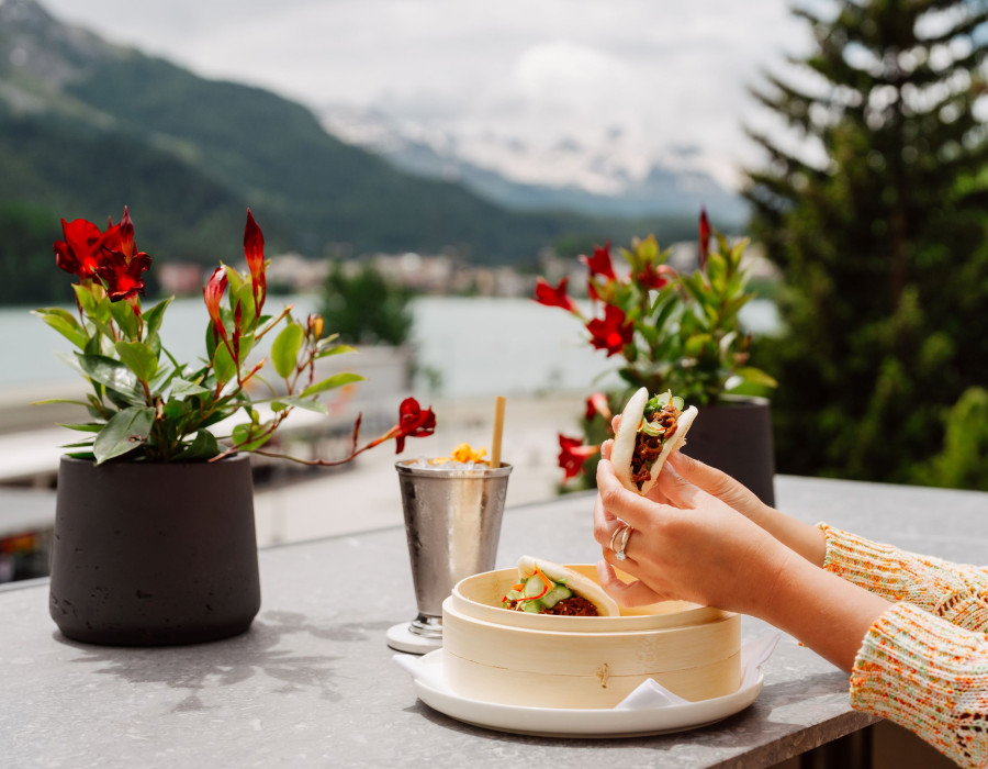 A woman taking a sandwich from her plate 