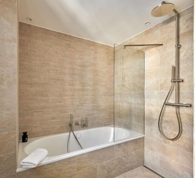  La Margna Panoramic Suite Bathroom with large bathtub and shower 