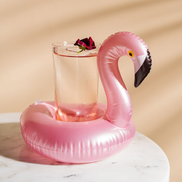 A pink cup holder in flampingo shape on a marble table at the luxury hotel st moritz